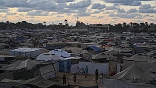 FILE: Dusk falls as children play at a temporary tent camp for displaced Palestinians in Deir al-Balah, in the central Gaza, 6 October 2025 