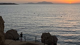  A tourist films the sunrise at the Red Sea city of Sharm el-Sheikh, Egypt, where Israeli and Hamas officials are set to hold indirect talks, on Tuesday, Oct. 7, 2025