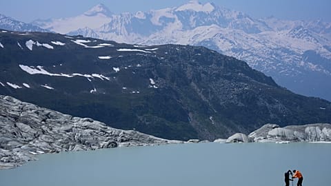 Researchers prepares camera at the Rhone Glacier near Goms, Switzerland, on June 10, 2025. Photo by Matthias Schrader