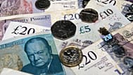 An assorted collection of UK coins and bills, illustrating the wealth gap in Britain.