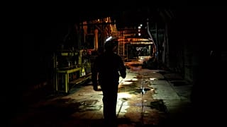 A worker walks along an internal corridor in a damaged DTEK thermal power plant after a Russian attack in Ukraine, 2 May, 2024