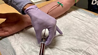 A clinical researcher draws blood from a study participant at Oregon Health & Science University's Knight Cancer Institute in Portland, 14 March, 2022