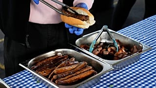 FILE: A worker prepares a "Democracy Sausage" at the Marrickville Public School in Sydney, 3 May 2025