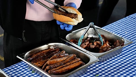 FILE: A worker prepares a "Democracy Sausage" at the Marrickville Public School in Sydney, 3 May 2025