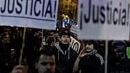 Protestors shout slogans as they hold banners reading 'Justice' during a demonstration against austerity measures and the approval of the budget for 2013 by the Spanish govern
