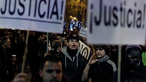 Protestors shout slogans as they hold banners reading 'Justice' during a demonstration against austerity measures and the approval of the budget for 2013 by the Spanish govern