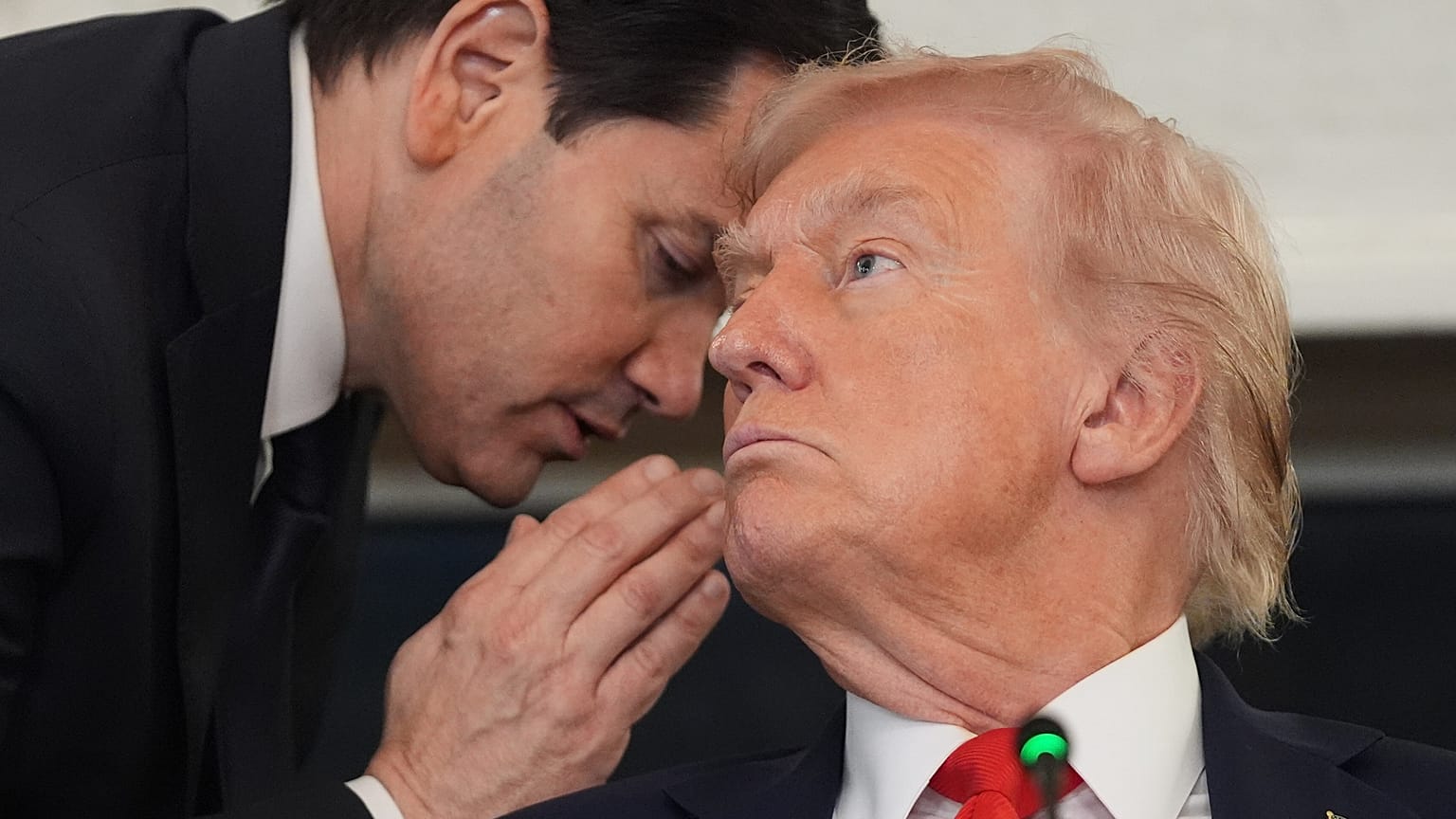 US Secretary of State Marco Rubio whispers to President Donald Trump during a roundtable meeting in the State Dining Room at the White House, 8 October 2025