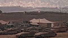 دبابات إسرائيلية في منطقة تحشيد قرب الحدود الإسرائيلية-الغزية، كما يُرى من جنوب إسرائيل، يوم الخميس 9 أكتوبر 2025، عقب الإعلان عن اتفاق وقف إطلاق النار بين إسرائيل وحماس 