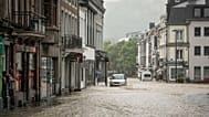 A car is parked on a flooded street in the center of Spa, Belgium, Wednesday, July 14, 2021. 