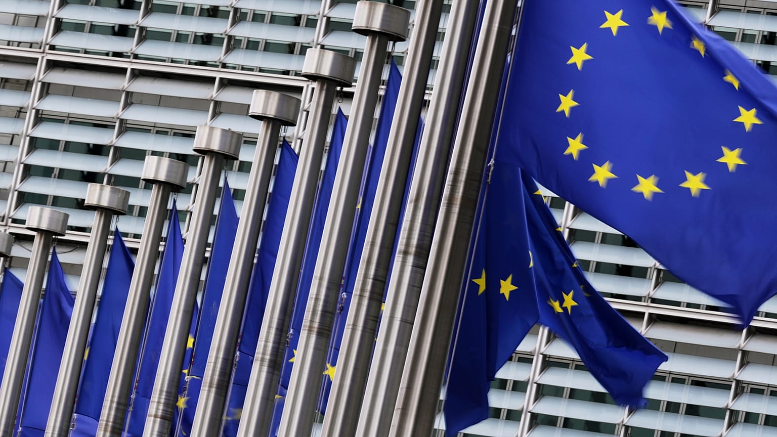 FILE: European flags flap in the wind outside EU headquarters in Brussels, 3 September 2025