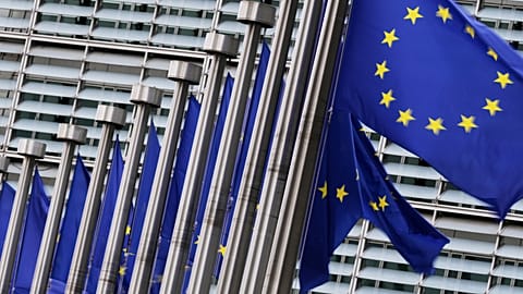 FILE: European flags flap in the wind outside EU headquarters in Brussels, 3 September 2025