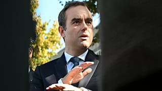 Reappointed French Prime Minister Sebastien Lecornu speaks with journalists as he visits a police station in L'Hay-les-Roses, outside Paris, Saturday, Oct. 11, 2025. (Martin L
