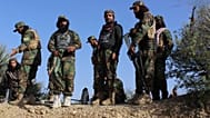 Afghan servicemen guard along the border in the Zazai Maidan district of Khost province, Afghanistan, Sunday, Oct. 12, 2025, after overnight clashes with Pakistan's forces. 