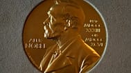 File - A Nobel Prize medal is displayed before a ceremony at the Swedish Ambassador's Residence in London, Monday, 6 December 2021. 