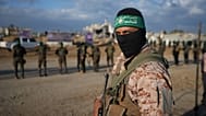 FILE: Hamas militants deploy and take up positions during a hostage release in Khan Younis, 1 February 2025