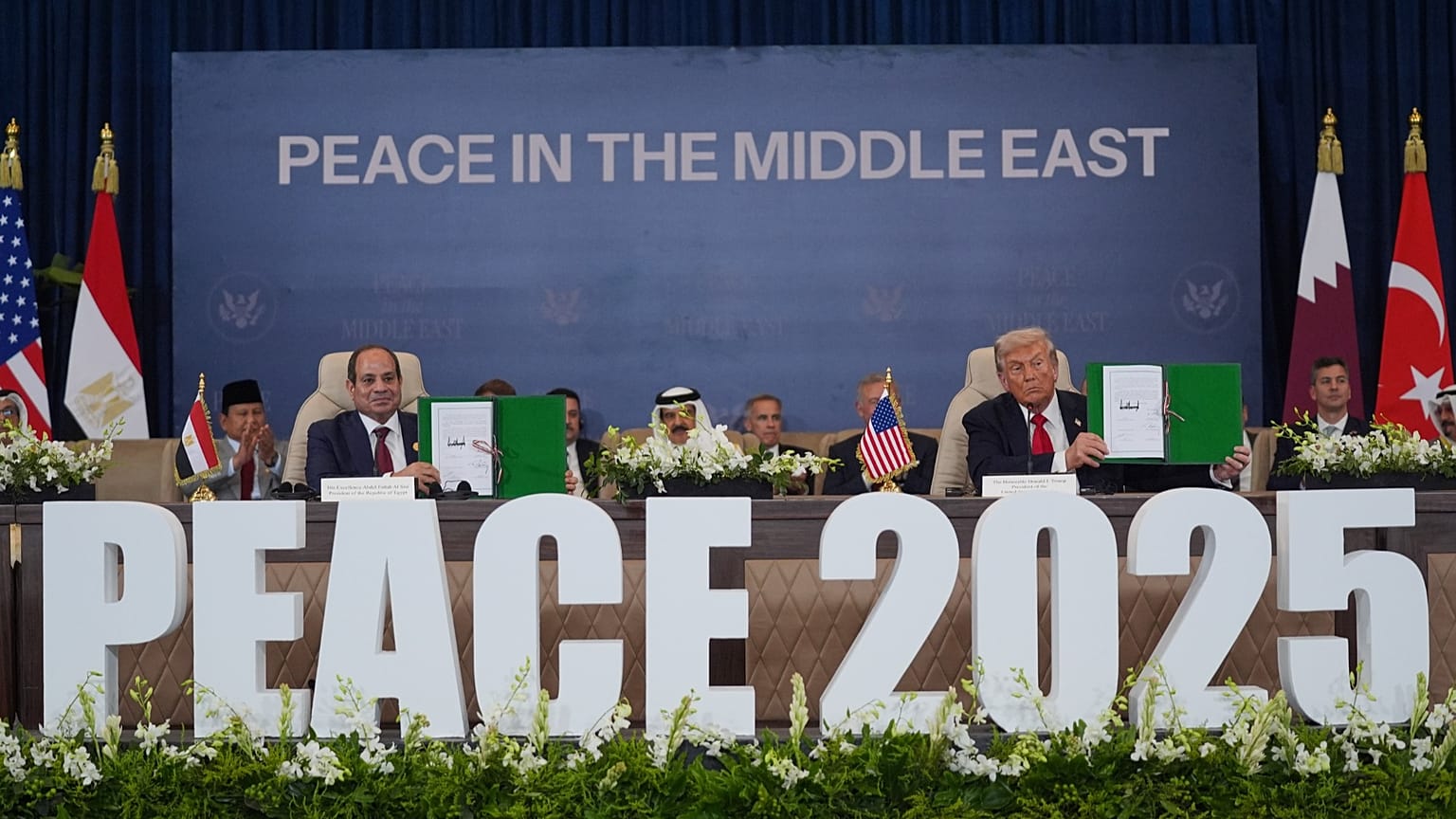 President Donald Trump and Egypt's President Abdel-Fattah el-Sissi hold signed documents during peace summit in Sharm El Sheikh, Egypt. Oct. 13, 2025.