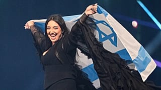 FILE - Singer Yuval Raphael waves Israel's national flag during a dress rehearsal for the 69th Eurovision Song Contest, in Basel, Switzerland, 16 May, 2025