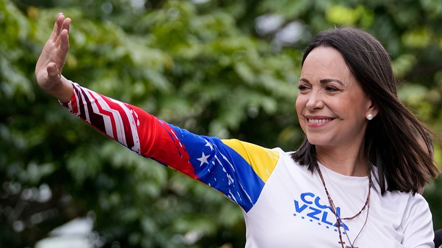 FILE - Opposition leader Maria Corina Machado waves from atop a truck in Caracas, Venezuela, Thursday, July 25, 2024