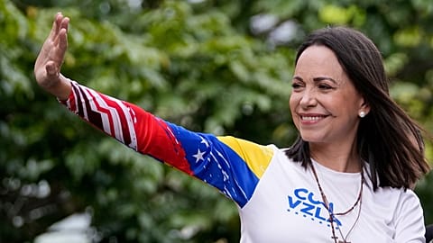 FILE - Opposition leader Maria Corina Machado waves from atop a truck in Caracas, Venezuela, Thursday, July 25, 2024
