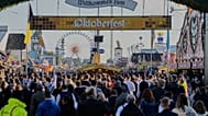Visitors walk to the re-opening of the Oktoberfest that was closed since the morning after a bomb threatening in Munich, Germany, Wednesday, Oct.1, 2025.