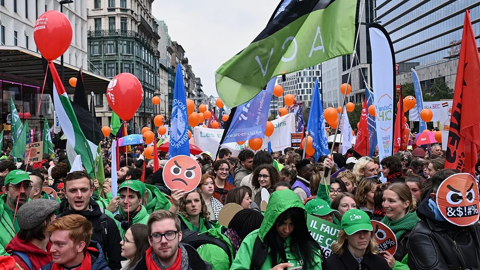 People march with signs crossed out with the number 67, referring to pension age, during a demonstration and general strike in Brussels, Tuesday, Oct. 14, 2025