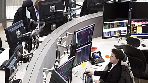 File - Analysts work at the Euronext headquarters in the business district la Defense, outside Paris, Tuesday, 10 January 2017. 