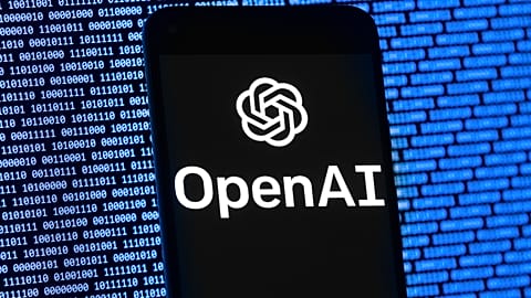 The OpenAI logo appears on a mobile phone in front of a computer screen with random binary data, Thursday, 9 March 2023, in Boston.