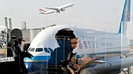 Passengers walk through Beijing Capital International Airport, 19 November, 2016