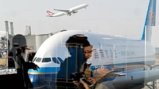 Passengers walk through Beijing Capital International Airport, 19 November, 2016
