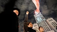 FILE: An image of imprisoned Polish minority activist in Belarus, Andrzej Poczobut, is projected on the Palace of Culture and Science in downtown Warsaw, 25 September 2021