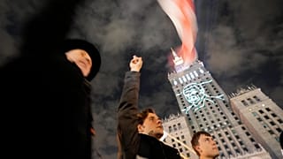 FILE: An image of imprisoned Polish minority activist in Belarus, Andrzej Poczobut, is projected on the Palace of Culture and Science in downtown Warsaw, 25 September 2021