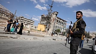 عناصر الأمن السوري على الحراسة بينما يغادر السكان أحياء الشيخ مقصود والأشرفية في مدينة حلب بسوريا، يوم الثلاثاء 7 أكتوبر 2025
