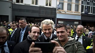 PVV leader Geert Wilders, poses for a selfie with supporters during his campaign.