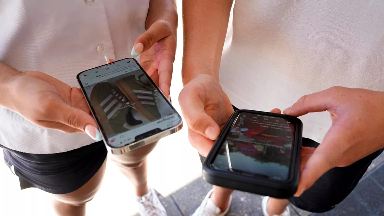 A pair of teenagers use their phones to view social media in Sydney on Nov. 8, 2024.