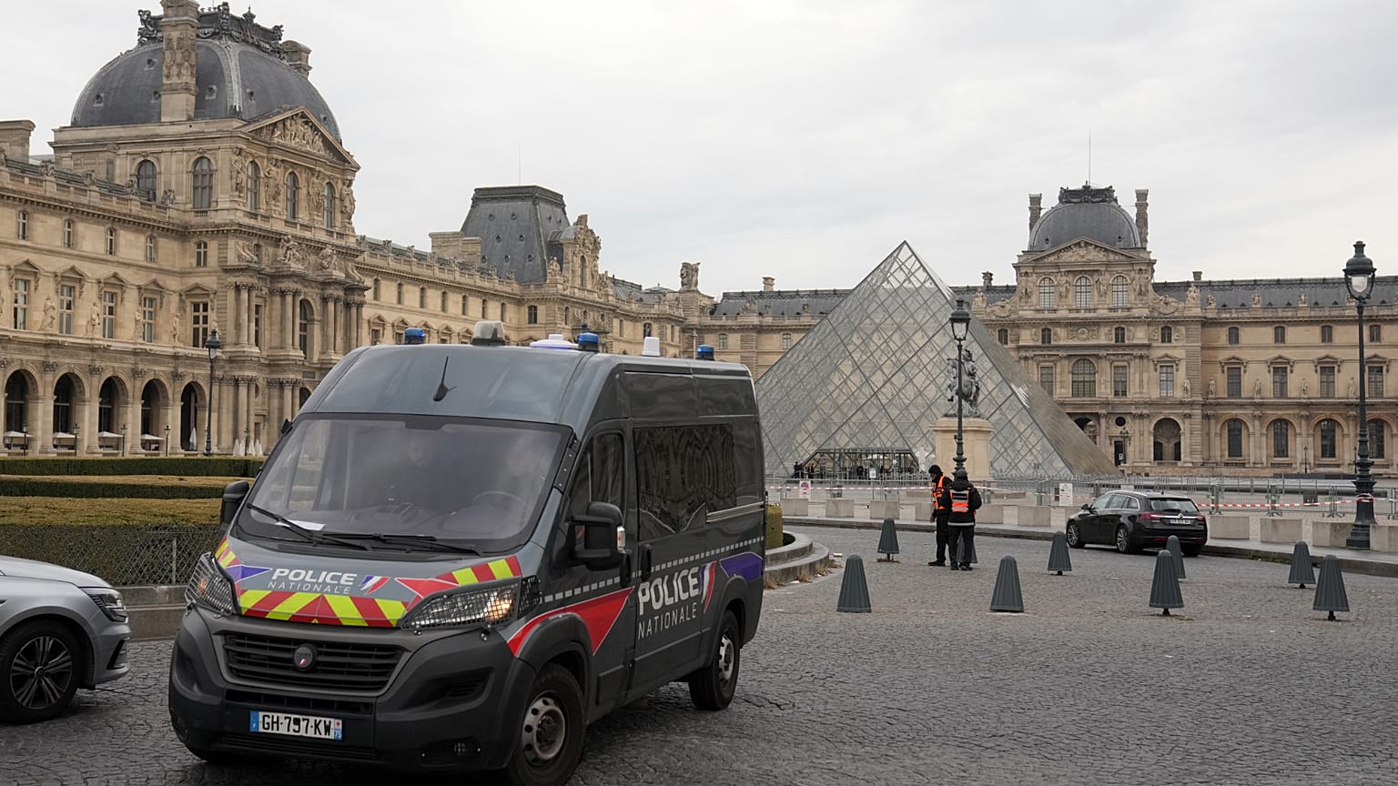 A police car patrols in the courtyard of the closed Louvre museum after a robbery Sunday, Oct. 19, 2025 in Paris. 