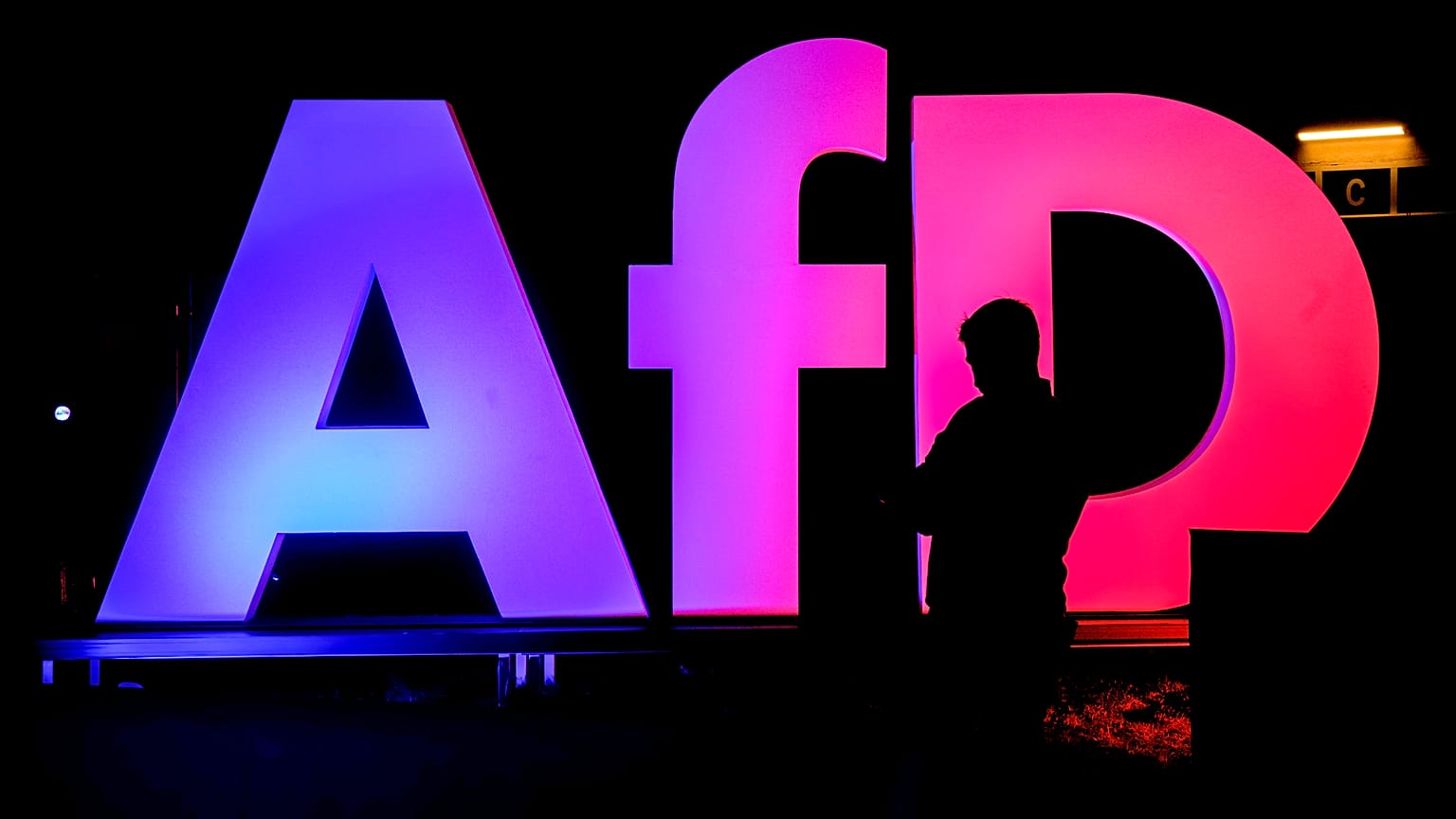 FILE - A man stands in front of the logo at the AfD party headquarters in Berlin, Germany. 23 Feb. 2025.