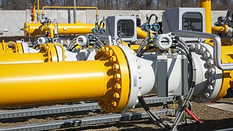FILE: A man walks by pipelines of the national natural gas distribution network outside Ungheni, Moldova, 4 March 2015