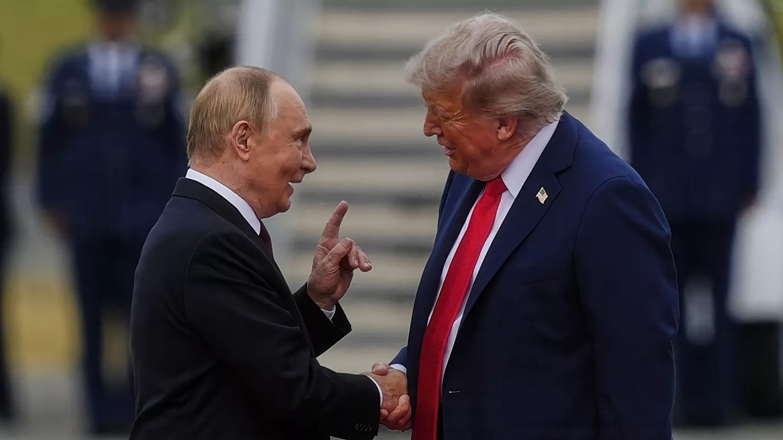 President Donald Trump, right, shakes the hand of Russia's President Vladimir Putin