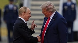 President Donald Trump, right, shakes the hand of Russia's President Vladimir Putin