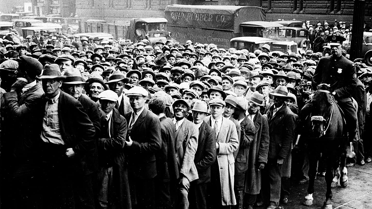 FILE - Thousands of unemployed people gather outside City Hall in Cleveland during the Great Depression.