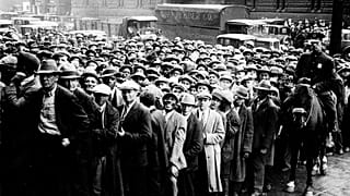 FILE - Thousands of unemployed people gather outside City Hall in Cleveland during the Great Depression.