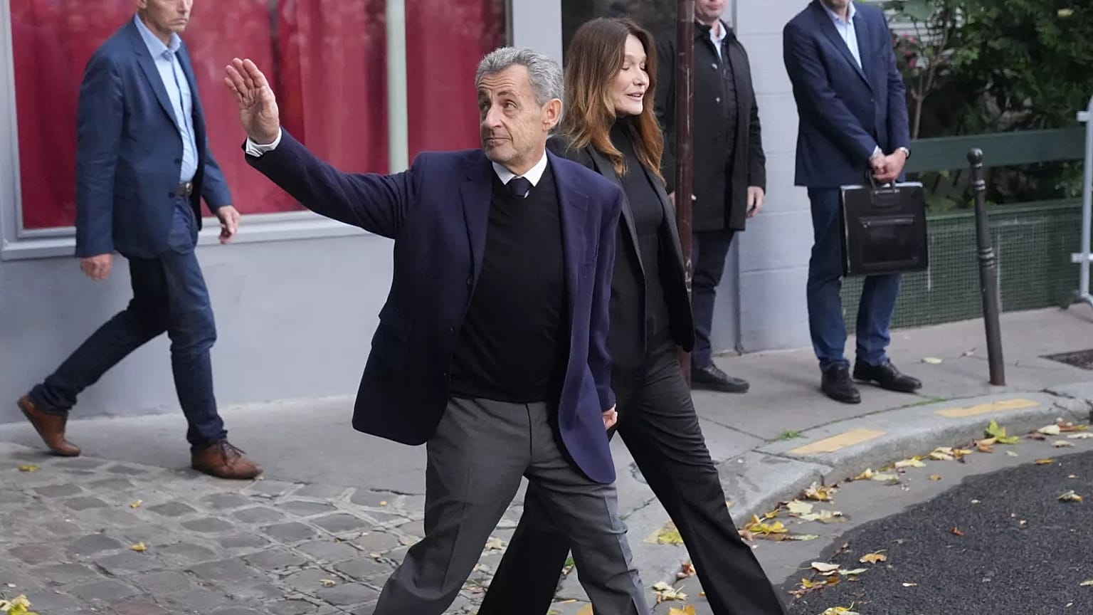 Former French President Nicolas Sarkozy and his wife Carla Bruni-Sarkozy leave their home in Paris, 21 October 2025