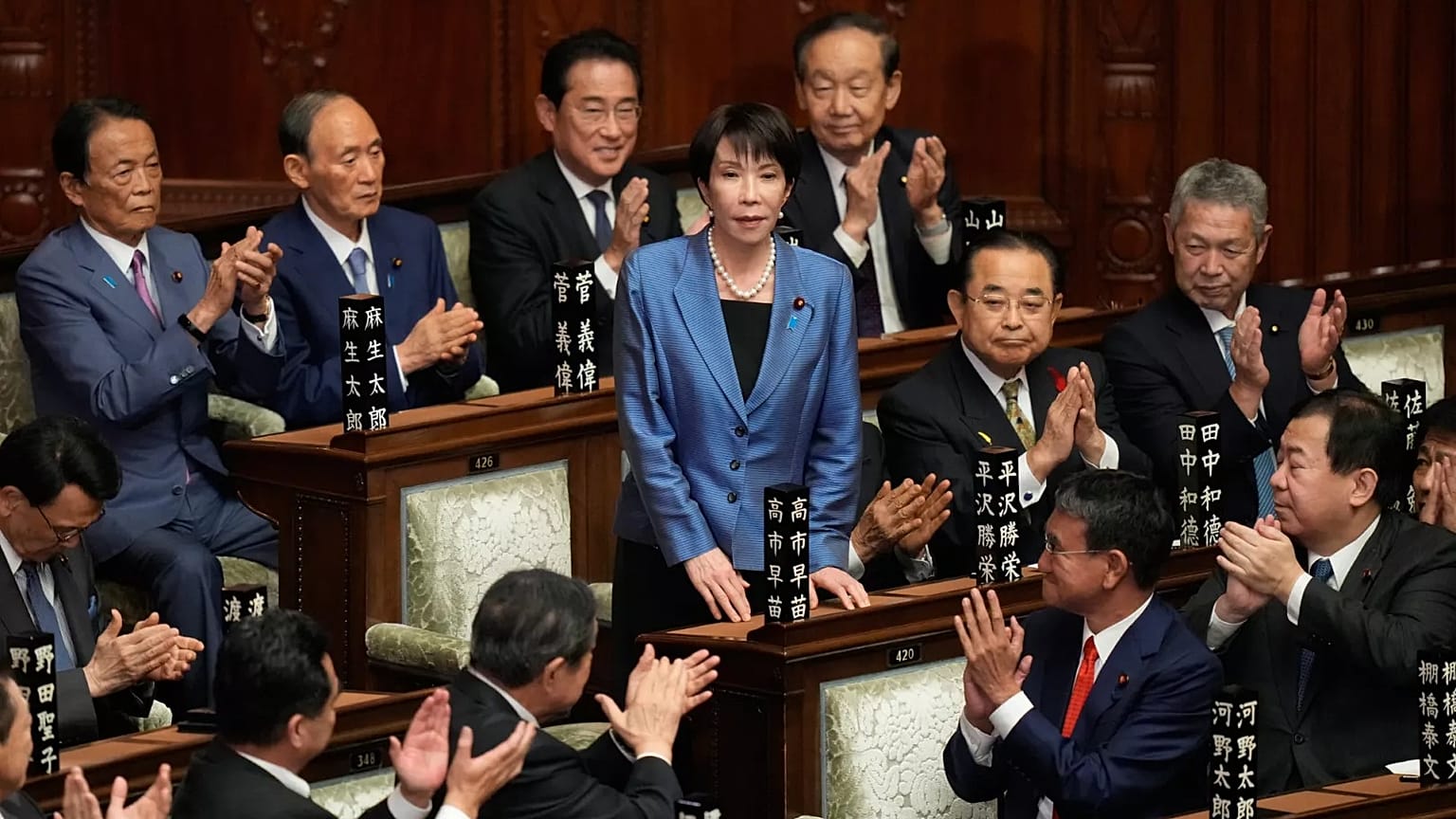 Lawmakers applaud as Sanae Takaichi, center, is elected as Japan's new prime minister during the extraordinary session of the lower house, in Tokyo, Japan, Tuesday, Oct. 21, 