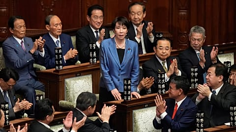 Lawmakers applaud as Sanae Takaichi, center, is elected as Japan's new prime minister during the extraordinary session of the lower house, in Tokyo, Japan, Tuesday, Oct. 21, 