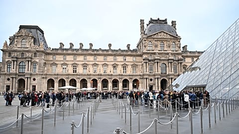 People queue outside the Louvre museum in Paris on Monday, Oct. 20, 2025, although it remains closed for the day after Sunday's jewels robbery.