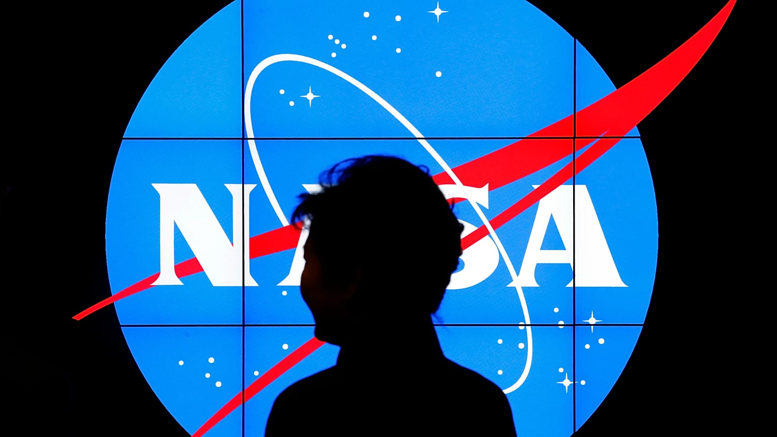 South Korean President Park Geun-hye walks past a NASA logo during a tour of projects and programs that are underway at the agency's Goddard Space Flight Center,