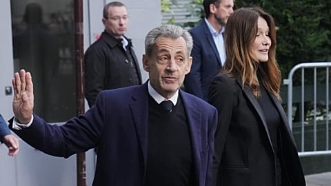 Nicolas Sarkozy and his wife Carla Bruni-Sarkozy leave their home Tuesday 21 October in Paris as Sarkozy heads to prison 