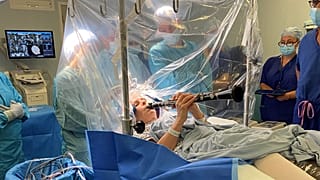 A patient plays the clarinet during a brain surgery to alleviate symptoms of Parkinson's disease.