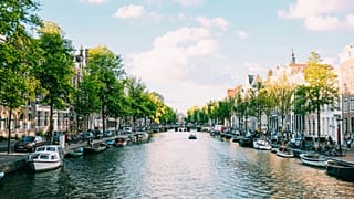 People travelling down the canal on a boat in Amsterdam, Netherlands.