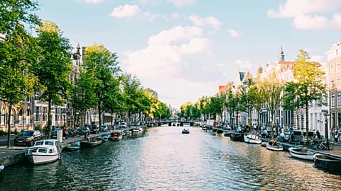 People travelling down the canal on a boat in Amsterdam, Netherlands.